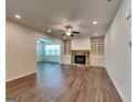 Open living space with fireplace, built-in shelving, and hardwood floors at 461 Best Friends Turn Aly, Mcdonough, GA 30252