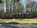 Charming single story red brick home with black shutters, white walkway, and covered front porch at 4063 Windsor Castle Way, Decatur, GA 30034