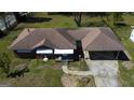 Aerial view of a single story brick house and carport showing the roof at 4487 Berkshire Rd, Forest Park, GA 30297