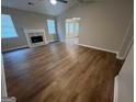 Bright living room with hardwood floors, a white mantle fireplace, and ample natural light at 260 Countryside Ln, Covington, GA 30016