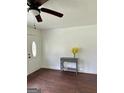 Inviting entryway with hardwood floors, a decorative console table and a ceiling fan at 1322 S Hicks Cir Nw, Conyers, GA 30012