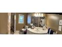 Full bathroom with a single sink vanity, neutral walls, framed mirror, and shower with a patterned curtain at 2387 Shire Ct, Austell, GA 30106