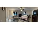 Spacious bedroom featuring a ceiling fan, sitting area, and large windows providing ample natural light at 2387 Shire Ct, Austell, GA 30106