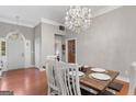 Bright dining room with modern chandelier, natural light, and wooden floors at 2615 Hampton Locust Grove Rd, Locust Grove, GA 30248