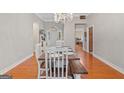 Bright dining room with chandelier, gray walls, and wooden table setting for six at 2615 Hampton Locust Grove Rd, Locust Grove, GA 30248