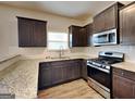 Well-equipped kitchen with granite countertops, stainless steel appliances, and ample storage at 483 Castle Top Ln, Lawrenceville, GA 30045