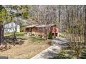 Brick home featuring a driveway, some landscaping, and a partial view of the backyard at 5217 Hollyhock Rd, Douglasville, GA 30135