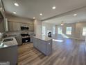 Bright, open kitchen featuring an island, stainless appliances, and seamless flow to the living area at 746 S. Bethany Rd., Locust Grove, GA 30248