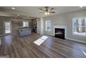 Open-concept living room featuring a fireplace and hardwood floors with a kitchen view at 746 S. Bethany Rd., Locust Grove, GA 30248
