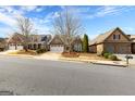 Street view showcases an attractive neighborhood featuring well-maintained lawns and charming brick facades at 365 Grand Teton Cir, Fayetteville, GA 30215