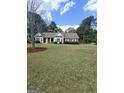 Well-maintained single-story home with a spacious front lawn and mature trees at 248 Valley Way, Hampton, GA 30228