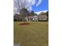 Landscaped front yard showcasing the single-story brick home and large shade tree at 248 Valley Way, Hampton, GA 30228