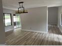 Bright room featuring new floors, slider to outside, and modern light fixture at 20 Fairway Ln, Peachtree City, GA 30269
