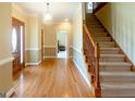 Inviting foyer with hardwood floors, staircase, and elegant lighting at 801 Streamside Dr, Mcdonough, GA 30252