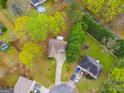 Aerial view showcases a well-maintained property nestled among lush greenery in a neighborhood at 324 Sue Ct, Temple, GA 30179