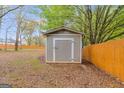 Well-maintained backyard storage shed provides practical outdoor storage and complements the landscape at 324 Sue Ct, Temple, GA 30179