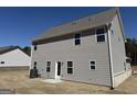 Rear view of home with light grey siding and white trimmed windows at 635 Cantrell Drive, Dallas, GA 30157