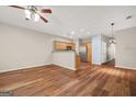 Open-concept living area with wood floors, modern ceiling fan, and a view into the kitchen with stainless steel appliances at 784 Brookside Parc Ln, Avondale Estates, GA 30002