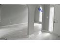 Bright living room featuring large windows, elegant arched doorways, and neutral colors at 2160 Creekview Trl, Decatur, GA 30035