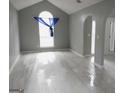Open-concept living area with sleek tile flooring, neutral paint, and natural light at 2160 Creekview Trl, Decatur, GA 30035