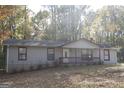 Inviting single-story home with neutral siding, red trim, and a well-maintained front yard at 321 Summerwood Ln, Stockbridge, GA 30281