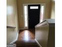 Inviting foyer with wood flooring and staircase leading to the upper level at 5734 Wellborn Oaks Ct, Lithonia, GA 30058