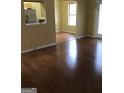 Spacious living room with hardwood floors and a view into the kitchen area at 5734 Wellborn Oaks Ct, Lithonia, GA 30058