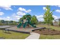 Community playground featuring green slides and a green shade structure at 600 Whitman Ln # 2026, Stockbridge, GA 30281