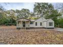 Quaint one-story home featuring a welcoming covered porch and charming curb appeal at 5122 Hillcrest Nw Dr, Covington, GA 30014