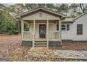 Inviting covered porch with wooden railings and steps, perfect for relaxing at 5122 Hillcrest Nw Dr, Covington, GA 30014