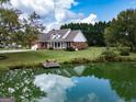 Charming brick home with a inviting front porch, set by a serene pond at 557 Arrowhead Cir, Rutledge, GA 30663