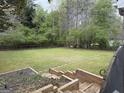 Large, green backyard featuring a stepped garden and a natural wood fence at 362 Mayfield Cir, Alpharetta, GA 30009