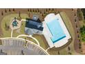 Aerial view of the community pool and recreation area, showcasing ample parking and playground area at 592 Whitman Ln # 2024, Stockbridge, GA 30281