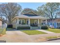 Inviting craftsman-style home featuring a covered porch and a neat yard with green grass at 988 Allene Sw Ave, Atlanta, GA 30310