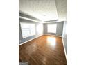 Spacious bedroom features gleaming hardwood floors, tray ceilings, and abundant natural light at 530 Shadowmoore Dr, Riverdale, GA 30274