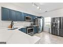 Well-lit kitchen with shaker cabinets, stainless steel appliances, and quartz countertops at 949 Pike Forest Dr, Lawrenceville, GA 30045