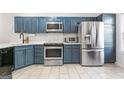 Bright kitchen featuring stainless steel appliances, shaker cabinets, and spacious countertops at 949 Pike Forest Dr, Lawrenceville, GA 30045