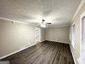 Inviting living room with stylish flooring, ceiling fan, and large windows at 1809 Mornington Ln, Snellville, GA 30078