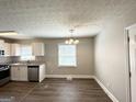 Bright kitchen and dining area featuring granite countertops and modern appliances at 3566 Fairlane Nw Dr, Atlanta, GA 30331