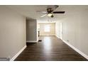 Spacious living room with hardwood floors and neutral paint, open to dining area at 3566 Fairlane Nw Dr, Atlanta, GA 30331