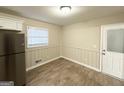 Bright dining area with wood-look floors and a white door at 518 Hammett Dr, Decatur, GA 30032