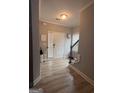Inviting foyer featuring wood flooring and a staircase to the upper level at 7703 Fawn Cir, Covington, GA 30014