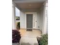 Charming front porch, featuring a stylish door, side window, and well-maintained landscaping at 7703 Fawn Cir, Covington, GA 30014