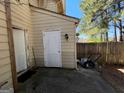 Enclosed backyard with a wooden fence, small storage area, and lawn mower at 8023 Creekstone Way, Riverdale, GA 30274