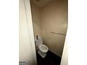 Small half-bathroom with white fixtures and wallpaper at 8023 Creekstone Way, Riverdale, GA 30274