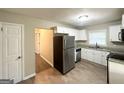 Well-lit kitchen featuring stainless steel appliances, granite countertops and bright cabinetry at 4267 Lamar St, Decatur, GA 30035
