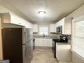Bright kitchen boasts stainless steel appliances, granite countertops, and modern cabinetry at 4267 Lamar St, Decatur, GA 30035