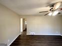 Spacious living room featuring wood floors and a ceiling fan with a light fixture at 4267 Lamar St, Decatur, GA 30035