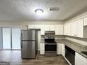 Modern kitchen featuring stainless steel appliances, granite countertops, and ample cabinet space at 2017 Lindsey Ln, Decatur, GA 30035