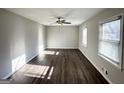 Bright living room with new flooring, ceiling fan, and windows providing ample natural light at 2317 Emerald Springs Dr, Decatur, GA 30035